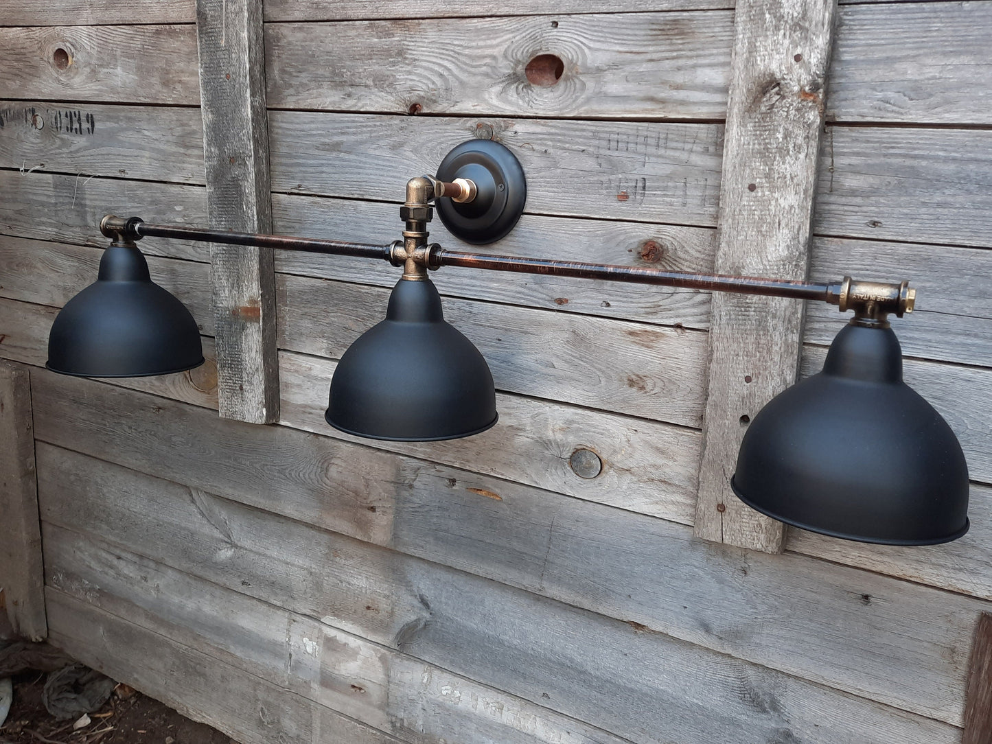 Long black wall sconce in industrial style. Rustic wall lamp for the bathroom.