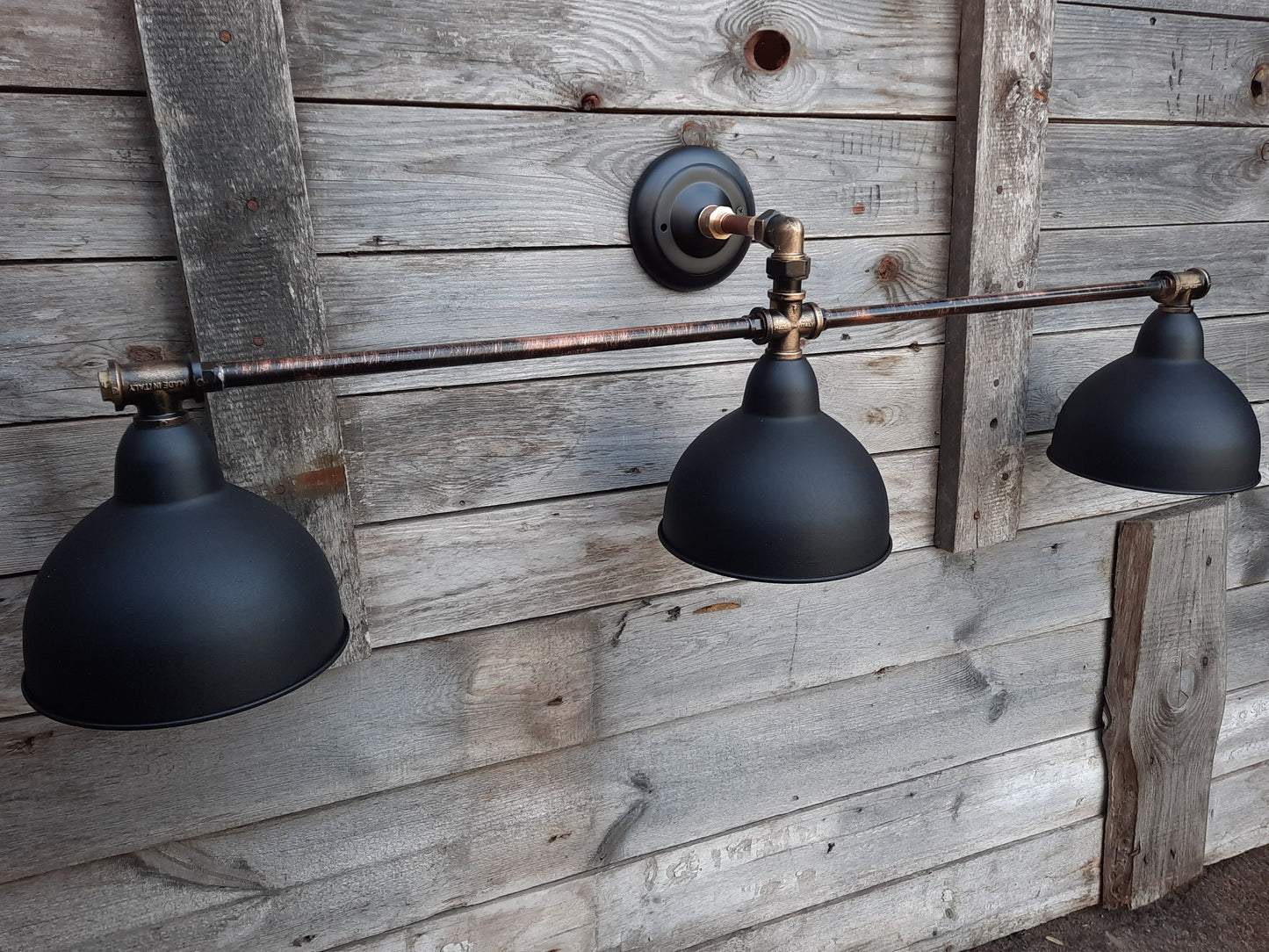Long black wall sconce in industrial style. Rustic wall lamp for the bathroom.