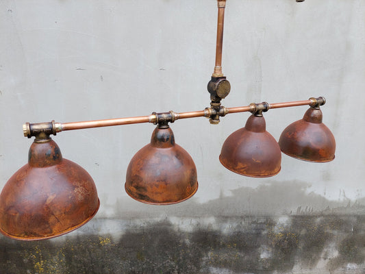Industrial rustic pendant light for a kitchen island. Hanging rusty chandelier for a steampunk farmhouse.